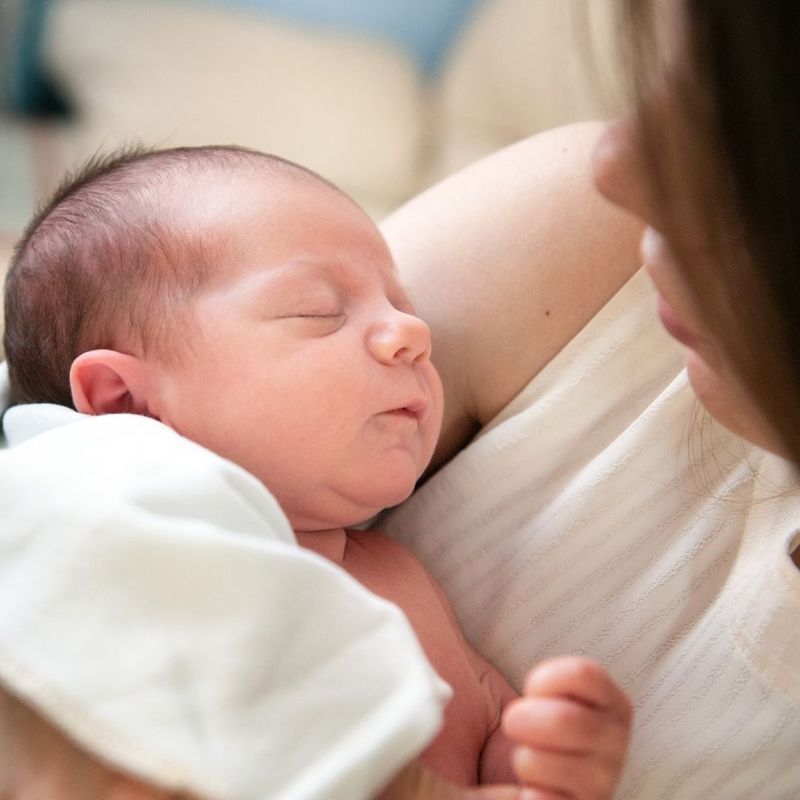 closeup of a mother holding a newborn closeup of a mother holding a newborn